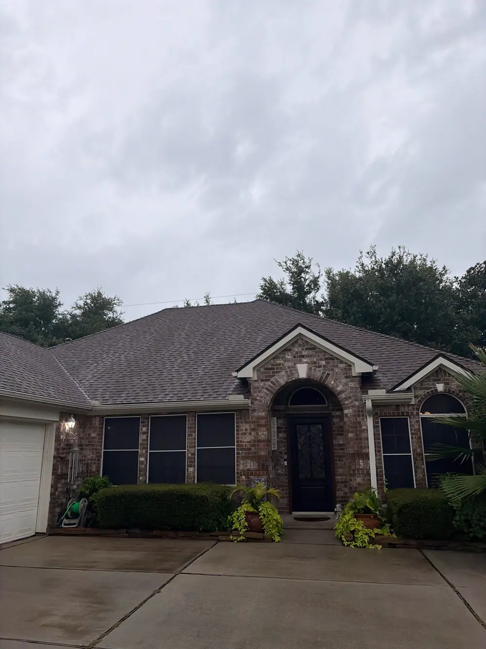 Completed architectural shingle roof on a brick one-story home in Cypress, TX