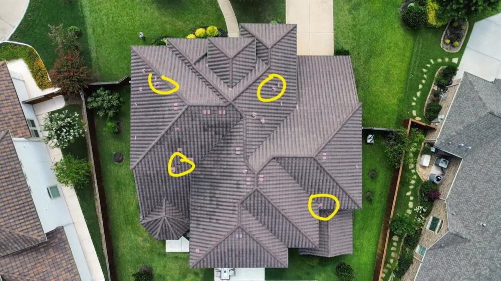 Aerial drone photo of a Houston-area roof with storm damage areas circled in yellow for an insurance claim